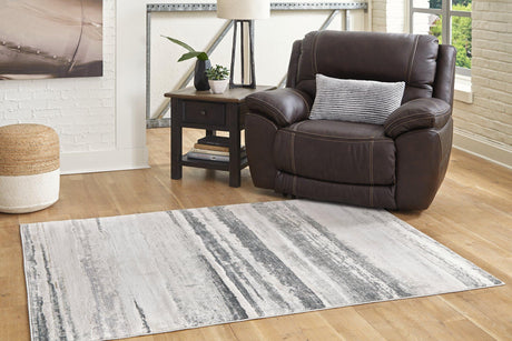 Ashley Furniture Abanett Rug featuring a plush, patterned design in warm neutral tones for cozy living spaces.