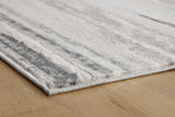 Ashley Furniture Abanett Rug featuring a plush, patterned design in neutral tones, perfect for enhancing living room decor.