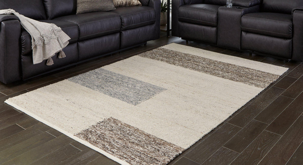 Ashley Furniture Barus Rug featuring a soft, woven texture with geometric patterns in neutral tones.