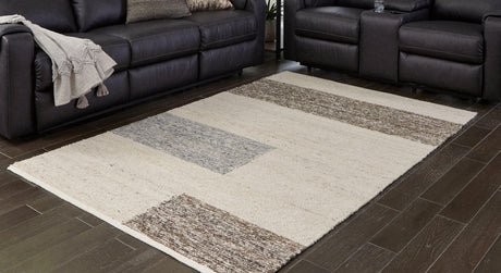 Ashley Furniture Barus Rug featuring a soft, woven texture with geometric patterns in neutral tones.