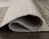 Ashley Furniture Barus Rug with intricate woven pattern in neutral tones, showcasing its soft, textured surface for home decor.