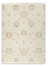 Ashley Furniture Calkin Rug featuring a textured, neutral-toned woven design suitable for living rooms or bedrooms.