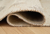Close-up of Ashley Furniture Calkin Rug showcasing its detailed woven pattern and texture in neutral tones.