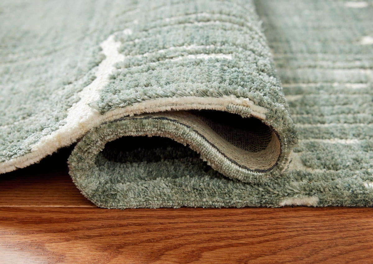 Ashley Furniture Cayworth Rug featuring a textured, neutral-toned design suitable for living rooms and bedrooms.
