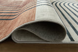 Close-up of Ashley Furniture Farrendale washable area rug with detailed pattern and soft texture in neutral tones.