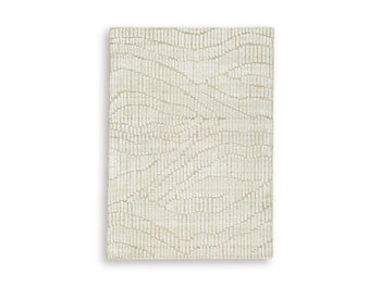 Ashley Furniture Jaseena area rug featuring a plush, patterned design in neutral tones, suitable for living rooms or bedrooms.