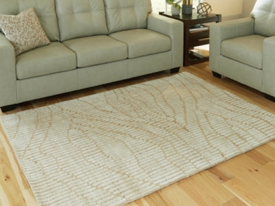 Ashley Furniture Jaseena area rug with intricate patterns in neutral tones, perfect for living rooms and bedrooms.