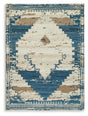 Ashley Furniture Varnler Rug featuring a textured pattern in neutral tones, shown in a cozy living room setting.