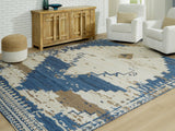 Ashley Furniture Varnler Rug with intricate woven design in neutral tones, suitable for living room or bedroom decor.