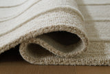 Close-up of a Teelgan Rug by Ashley Furniture showing detailed woven pattern and soft texture on a neutral background.