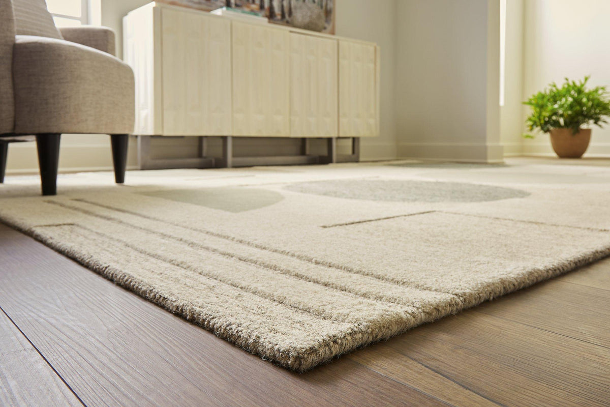 Ashley Furniture Dallane 8x10 rug with intricate patterns in neutral tones, showcasing a plush, woven textile design.