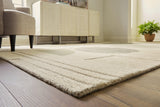 Ashley Furniture Dallane 8x10 rug with intricate patterns in neutral tones, showcasing a plush, woven textile design.