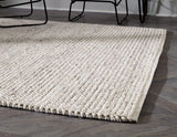 Ashley Furniture Jossick 5x7 rug with intricate patterns in neutral tones, perfect for living rooms or bedrooms.