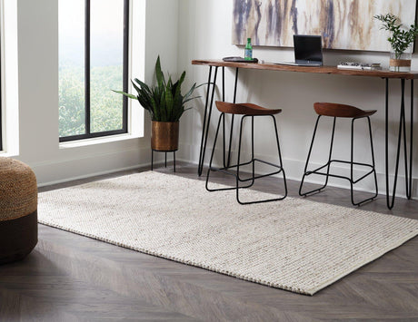 Ashley Furniture Jossick 7'8" x 10' rug with intricate pattern and soft texture, ideal for enhancing living room decor.