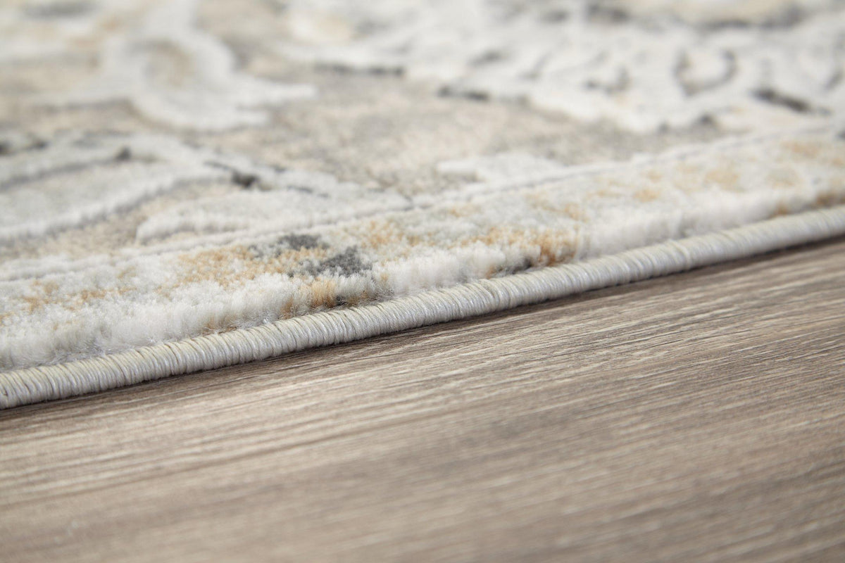 Ashley Furniture Kilkenny rug, 7'10" x 10'2", with intricate woven pattern and neutral tones, perfect for living room decor.