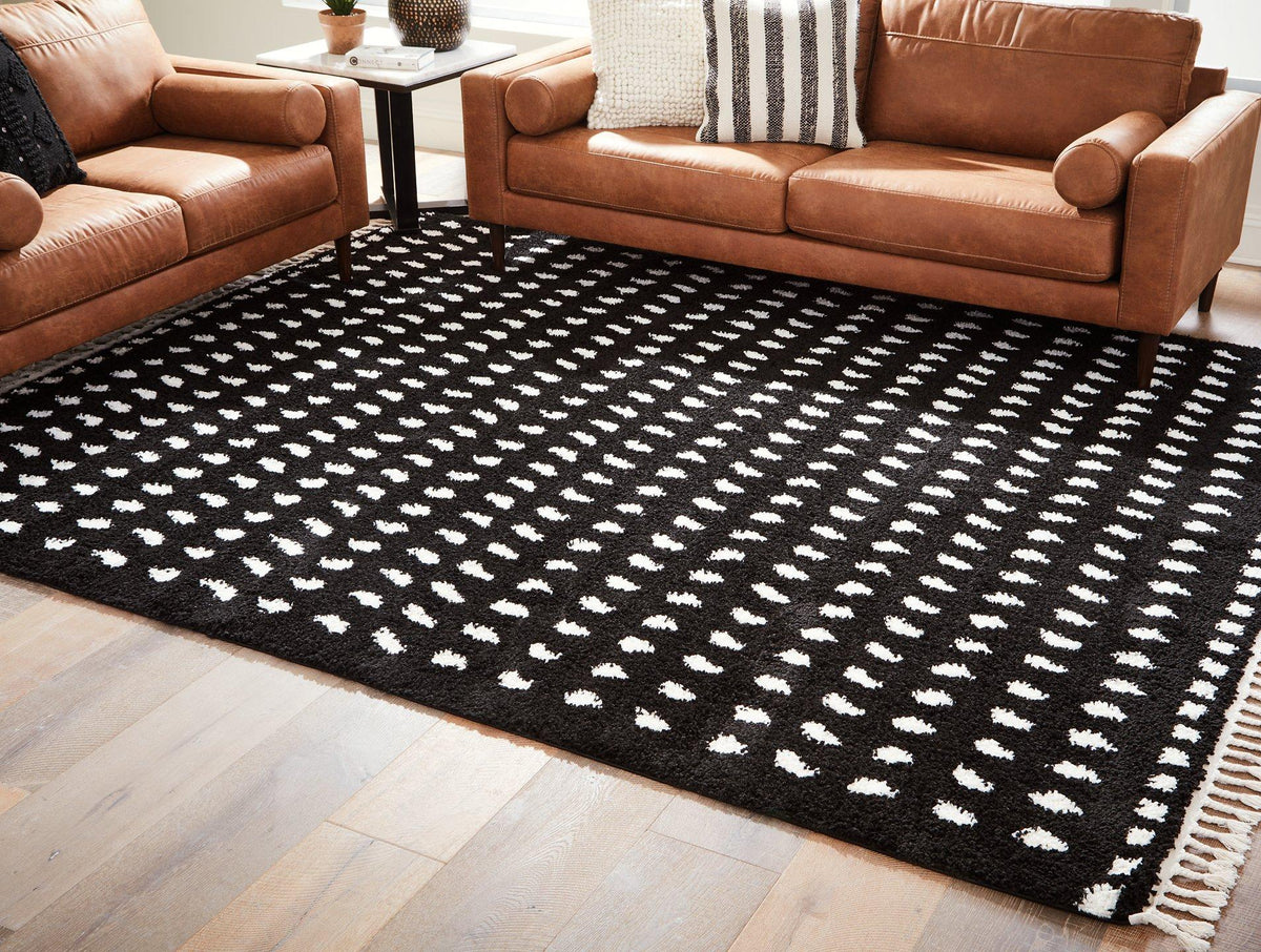 Ashley Furniture Minston 5' x 7' rug with intricate patterns and soft texture, ideal for enhancing living room decor.