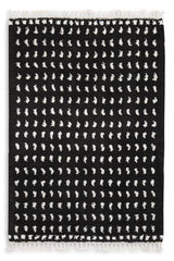 Ashley Furniture Minston 5' x 7' rug with intricate patterns and soft texture, ideal for living rooms or bedrooms.