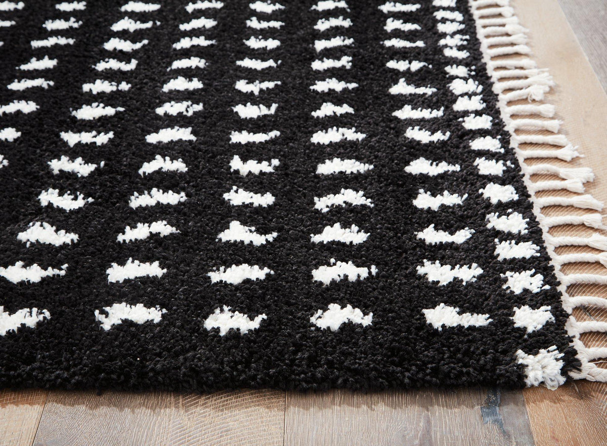 Ashley Furniture Minston 5' x 7' rug with a woven pattern, featuring neutral tones and soft texture for stylish home decor.