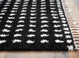 Ashley Furniture Minston 5' x 7' rug with a woven pattern, featuring neutral tones and soft texture for stylish home decor.