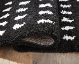 Ashley Furniture Minston 5' x 7' rug with intricate patterns and soft texture, ideal for enhancing living room decor.