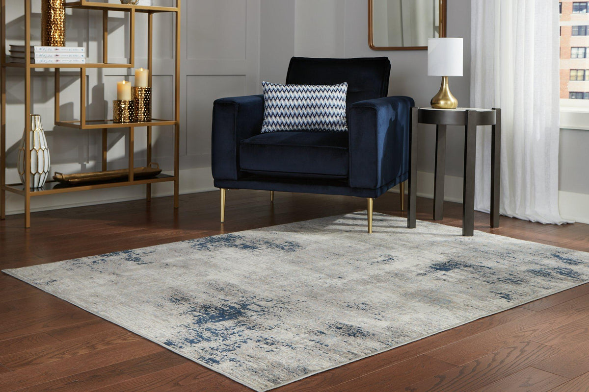 Wrenstow 7'10" x 10'3" Rug by Ashley Furniture featuring a stylish, patterned design in neutral tones on a plush surface.