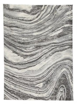 Ashley Furniture Wysdale 7'10" x 10'3" rug featuring a detailed pattern in neutral tones on a plush surface.