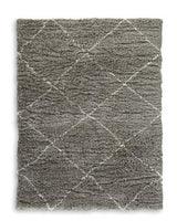 Wrenlow Rug by Ashley Furniture featuring intricate geometric patterns in neutral tones, perfect for living room or bedroom decor.