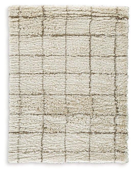 Wrenlow Rug by Ashley Furniture featuring a plush, patterned design in neutral tones, suitable for living room or bedroom decor.
