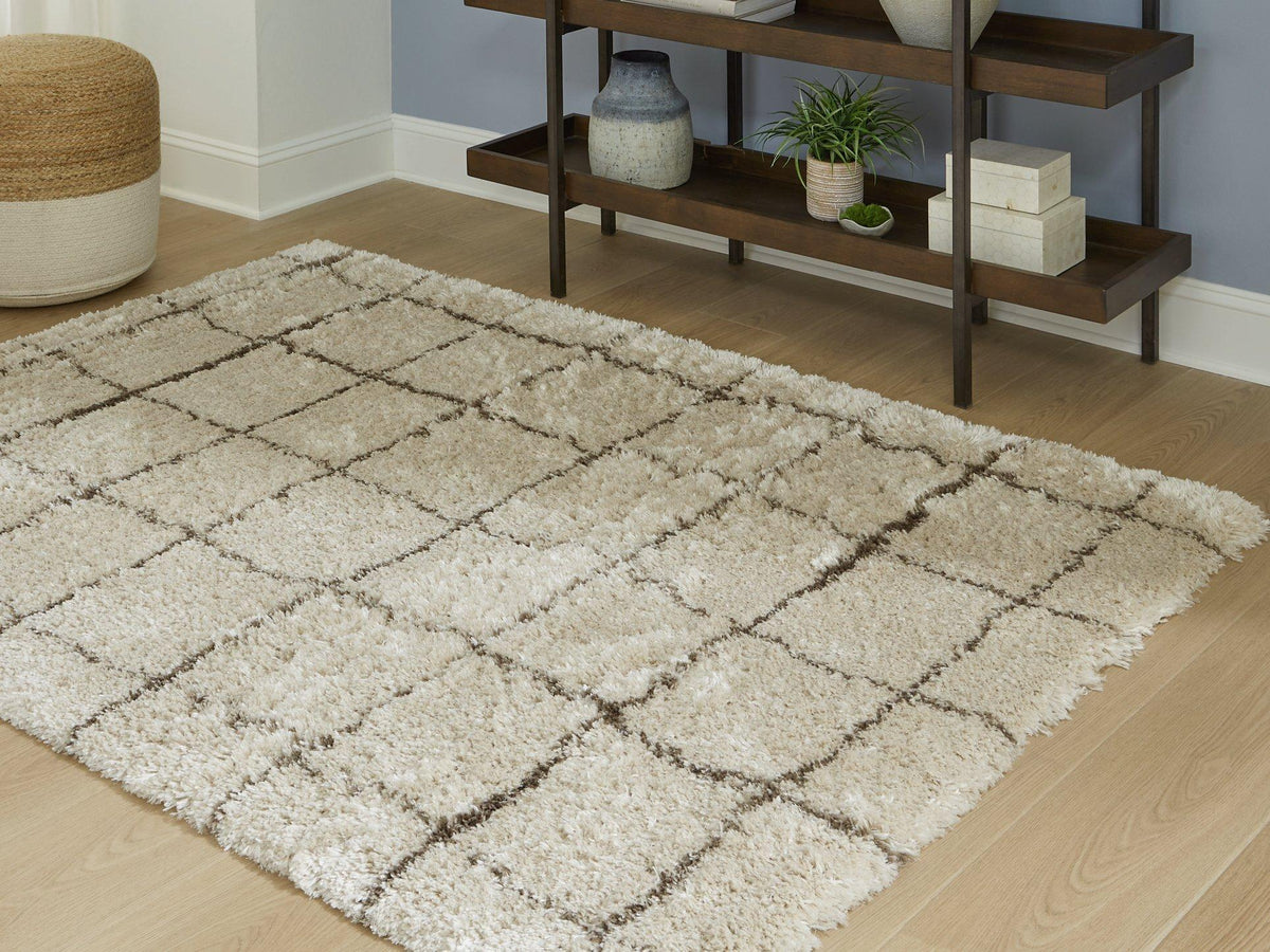Wrenlow Rug by Ashley Furniture featuring a soft, textured design in neutral tones, perfect for living room or bedroom decor.