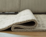 Large Ashley Furniture Maconville Rug with detailed woven pattern in neutral tones, showcasing texture and craftsmanship.