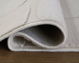Medium washable area rug from Ashley Furniture with a detailed pattern in neutral tones, suitable for living spaces.