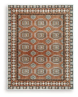 Medium Ashley Furniture Qaabiz Area Rug with intricate pattern, showcasing warm tones and textured design.