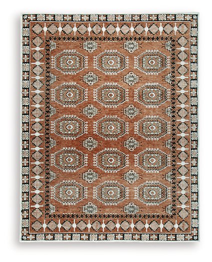 Medium Ashley Furniture Qaabiz Area Rug with intricate pattern, showcasing warm tones and textured design.