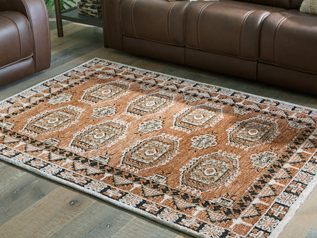 Medium Ashley Furniture Qaabiz Area Rug with intricate patterns in neutral tones, cropped view highlighting texture and design.