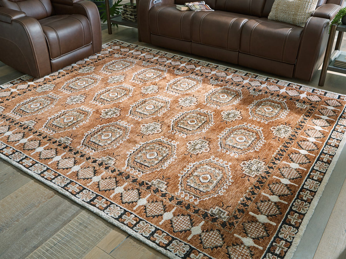 Medium Ashley Furniture Qaabiz Area Rug with intricate pattern, shown cropped for a close-up view of the design and texture.