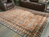 Medium Ashley Furniture Qaabiz Area Rug with intricate pattern, shown cropped for a close-up view of the design and texture.
