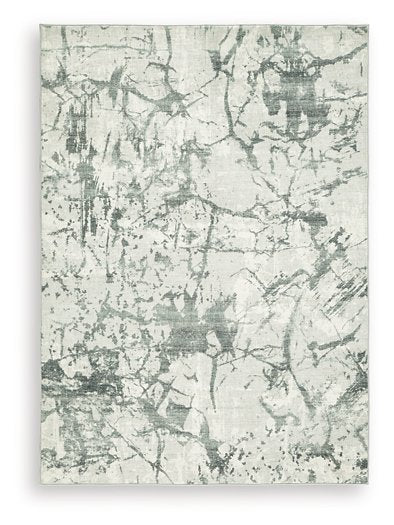 Medium Ashley Furniture Tobinbury washable area rug with a soft, textured design in neutral tones, suitable for living spaces.