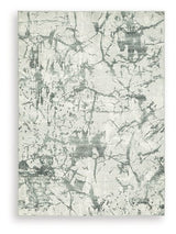 Medium Ashley Furniture Tobinbury washable area rug with a soft, textured design in neutral tones, suitable for living spaces.
