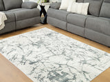 Medium Ashley Furniture Tobinbury washable area rug with a textured pattern in neutral tones, suitable for living rooms or bedrooms.