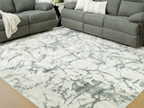 Medium Ashley Furniture Tobinbury washable area rug with intricate pattern in neutral tones, shown in a close-up crop.