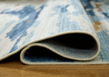 Medium washable rug from Ashley Furniture with a soft, patterned design featuring neutral tones for versatile home decor.