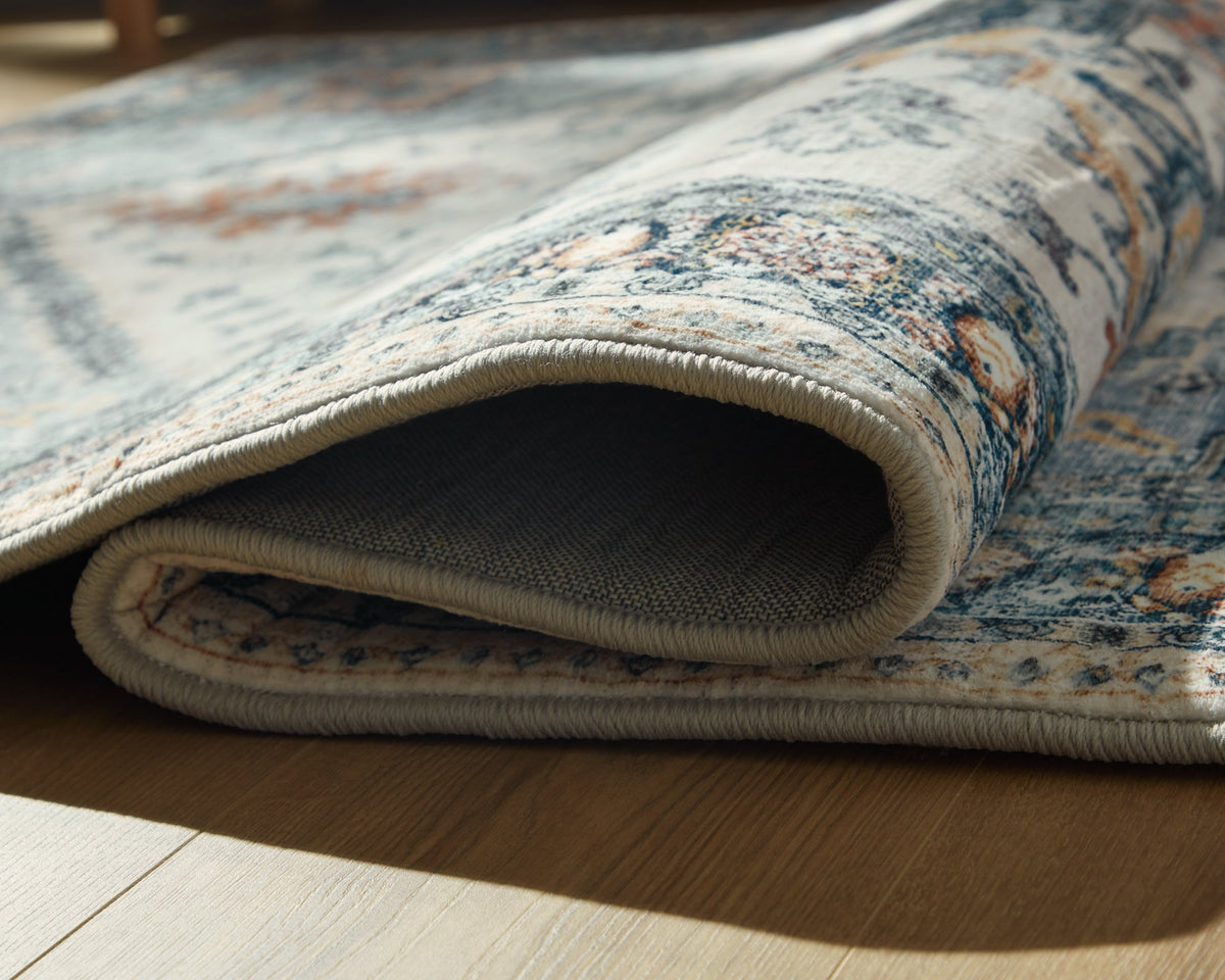 Medium Ashley Furniture Wallney Area Rug with intricate patterns and soft texture, ideal for living room or bedroom decor.
