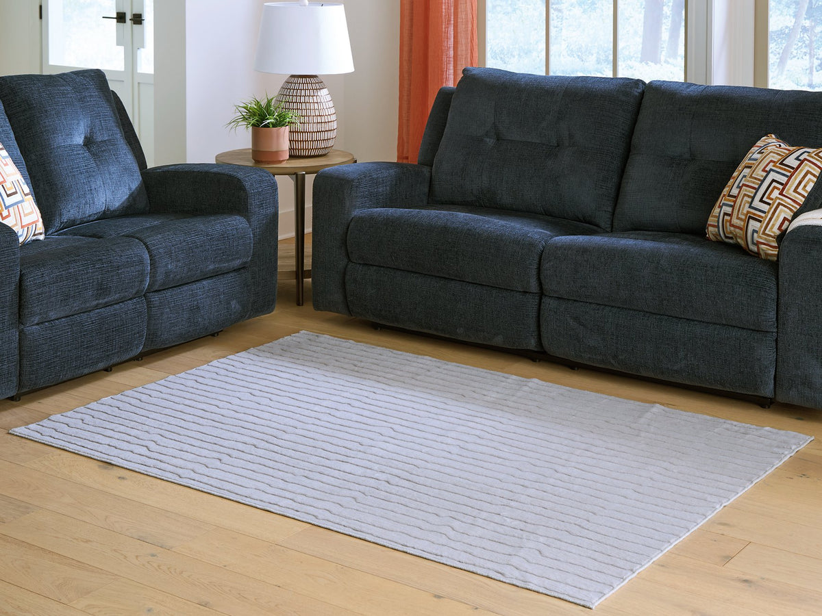 Medium washable area rug from Ashley Furniture, featuring a soft, durable design in a versatile pattern perfect for living spaces.