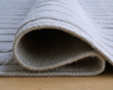 Medium washable area rug by Ashley Furniture with intricate pattern and soft texture, shown in detailed close-up image.