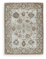 Ashley Furniture Ainswick Memory Foam Rug with plush, textured surface in neutral tones, ideal for cozy living spaces.