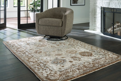 Ainswick memory foam rug by Ashley Furniture with plush, textured surface and neutral color, ideal for cozy living space decor.