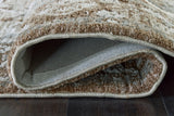 Close-up of Ashley Furniture Ainswick Memory Foam Rug showing soft, plush texture and detailed fiber weave in neutral tones.