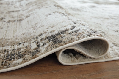 Close-up of Ashley Furniture Barricland Rug, showcasing its detailed pattern and textured surface in natural colors.