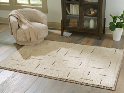 Ashley Furniture Clayman Rug with a textured 4x3-foot design, showcasing a soft, woven surface in neutral tones.