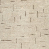 Ashley Furniture Clayman Rug swatch showing textured beige and brown woven fabric for living room or bedroom decor.